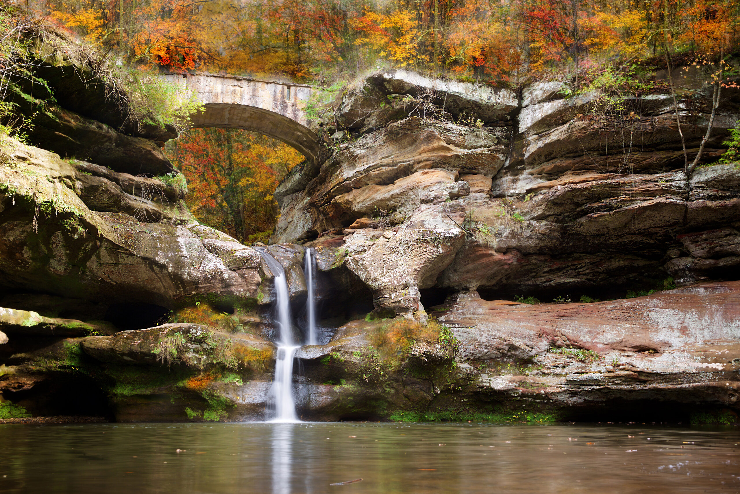 bridge and waterfall in hocking hills state park, ohio with blur