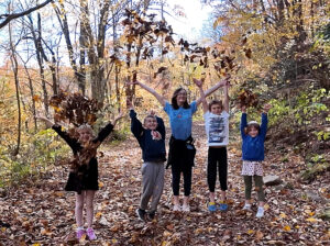 kids throwing leaves new
