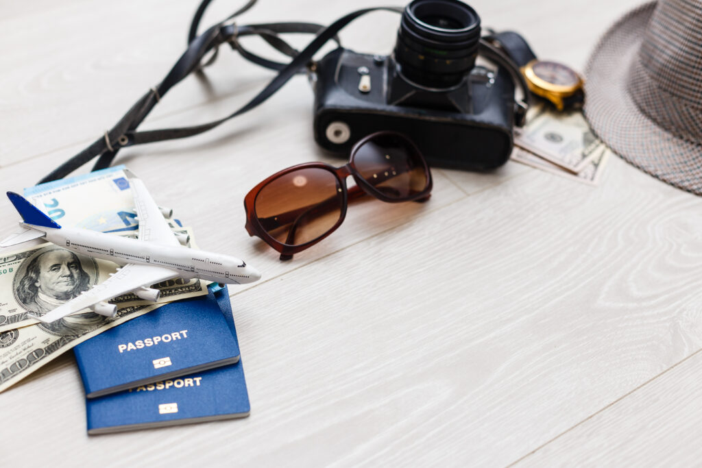 travel items are a compass, tickets, documents, money, a camera, a toy airplane. planning of air travel, holidays, business trips. advertising, banner.