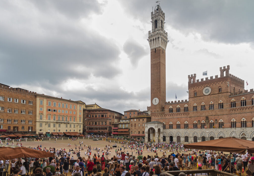 piazza del campo for the place of the palio horse race, with the public palace, siena, tuscany, italy